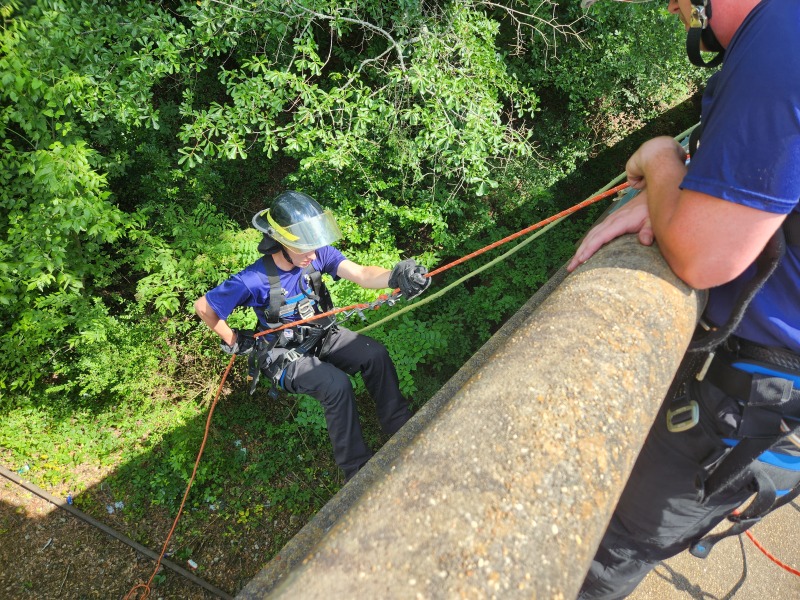 Cole Wilson walks down the side of the bridge