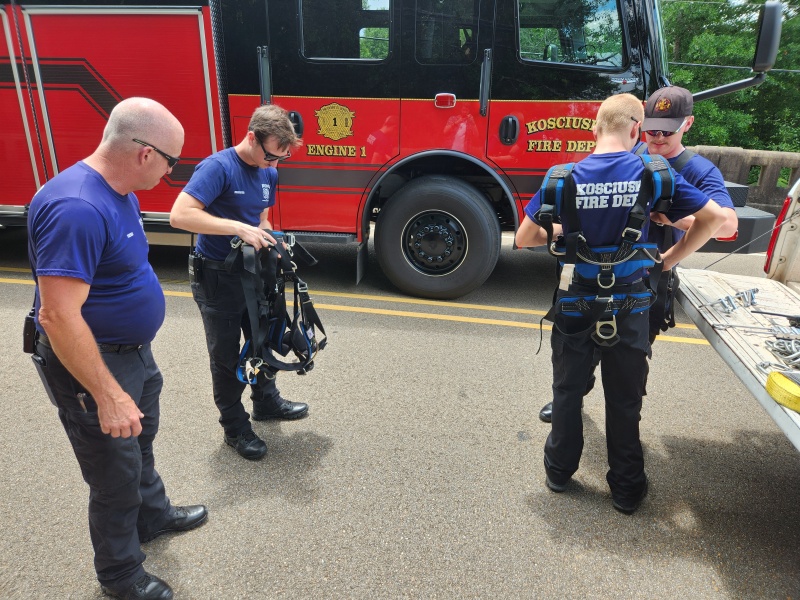KFD members getting outfitted to rappel.